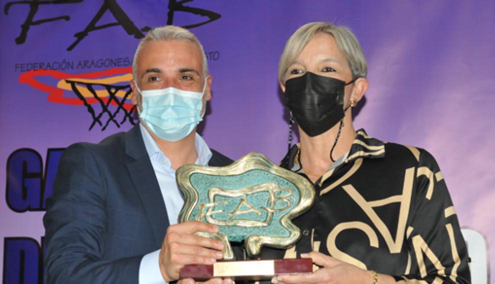 Alberto Pérez entrega a Anabel Sanagustín el premio al CBF Huesca por sus cuarenta años.