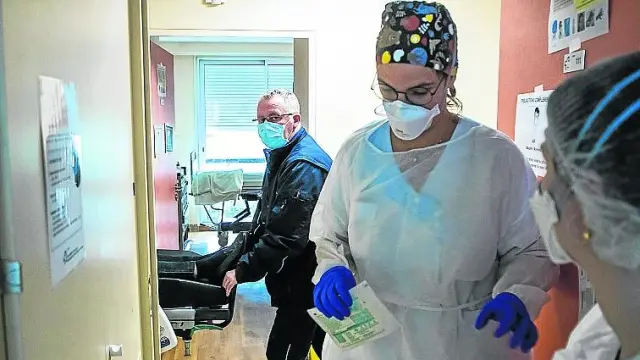 Una enfermera se prepara antes de asistir a un enfermo con covid en la ciudad francesa de Neuilly-sur-Seine.