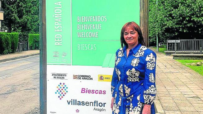 Nuria Pargada junto al cartel de la Reserva donde se ha colocado el de Villas en Flor.