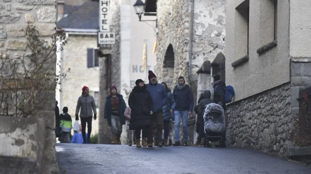Visitantes dando un paseo ayer por las calles de Sallent de Gállego.