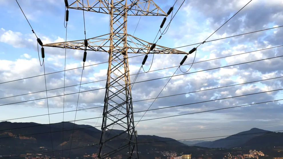 Una torre de transporte de energía perteneciente a red eléctrica, con la ciudad de Bilbao al fondo