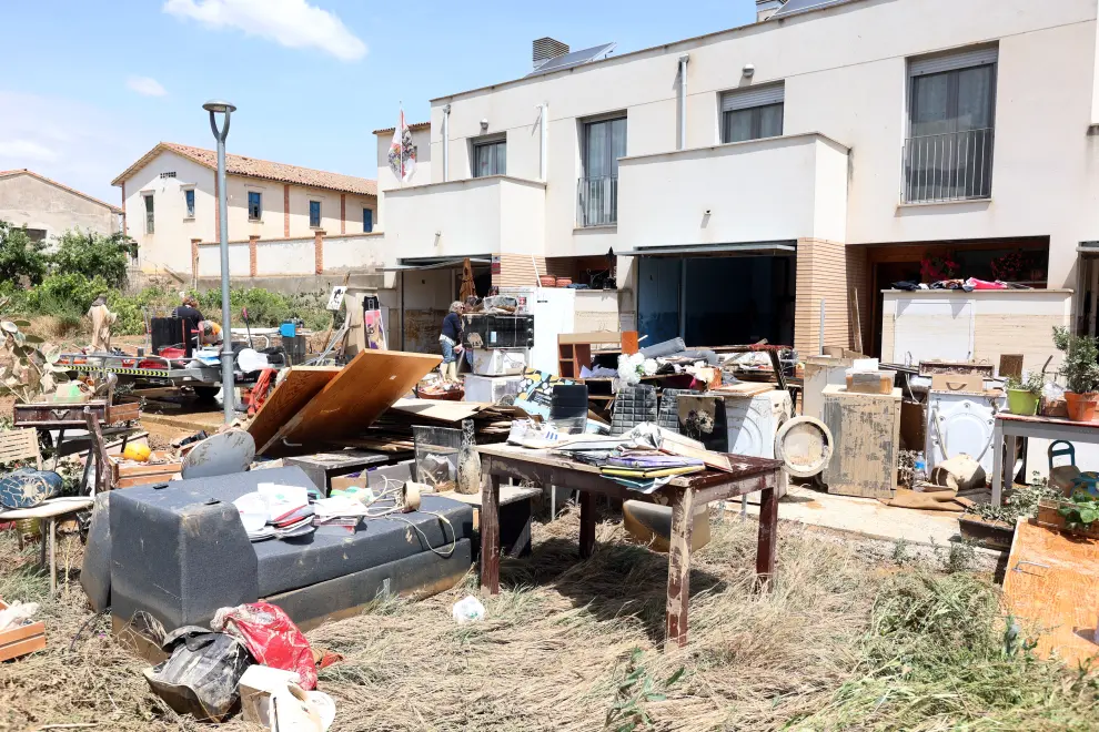 Los vecinos evalúan los daños causados por la crecida y limpian sus casas.