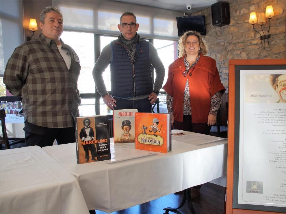 Fran Ponce, Francis Martín y Marian Bandrés junto al menú del restaurante Biarritz, donde se ha presentado esta iniciativa.