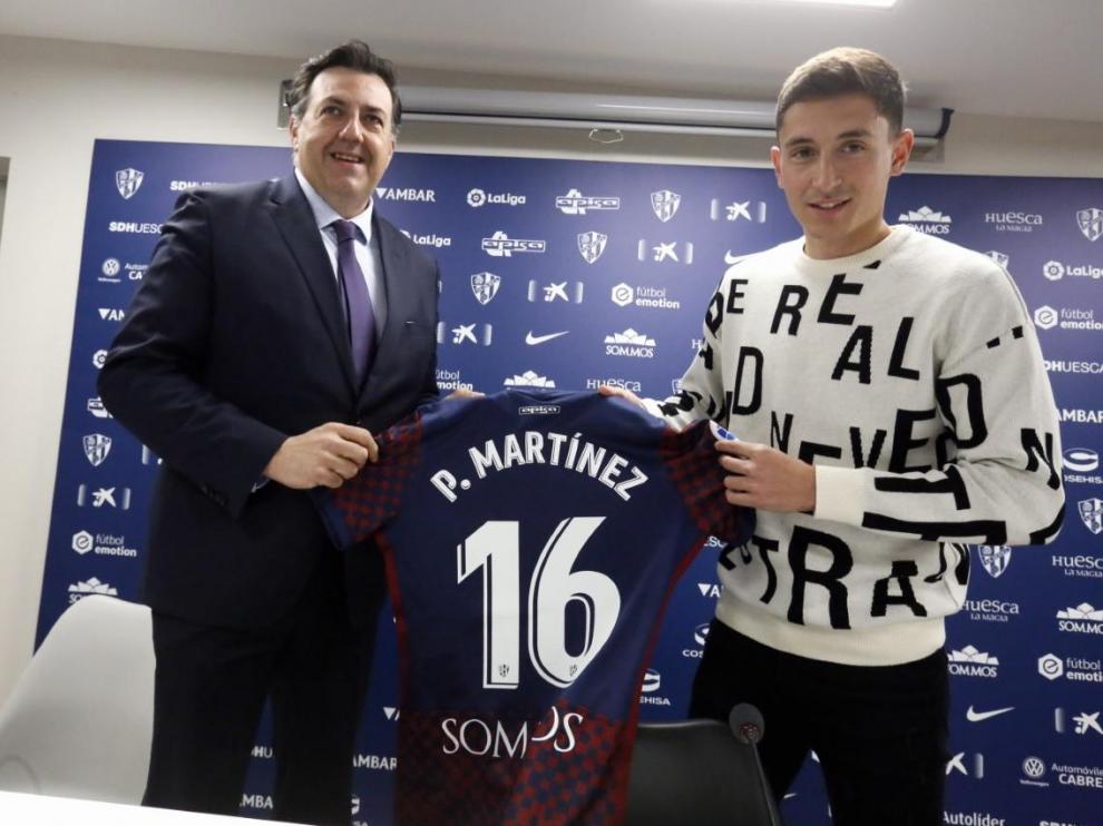 Pablo Martínez junto con Manolo Torres y la camiseta con el dorsal 16 que llevará en el Huesca