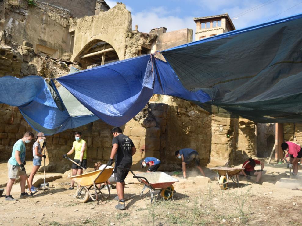 Jóvenes de un campo de trabajo impulsado por la Diócesis excavan en el entorno de la catedral de Huesca, donde se han hallado restos romanos, andalusíes y medievales