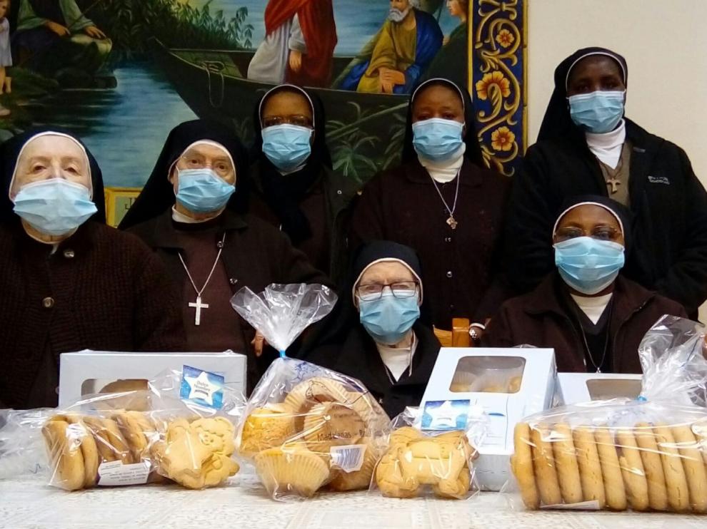 Las hermanas Capuchinas posan junto a los postres de su propia elaboración.