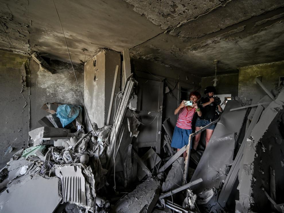 Un periodista toma imágenes tras un bombardeo en la ciudad ucraniana de Komyshuvakha.