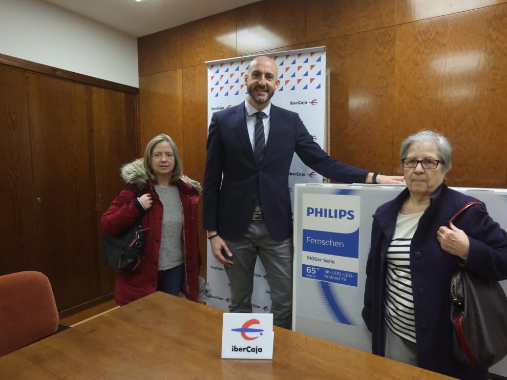 Isabel Catevilla Oliván recoge su premio acompañada de su hija y el director de la oficina principal de Ibercaja Huesca.